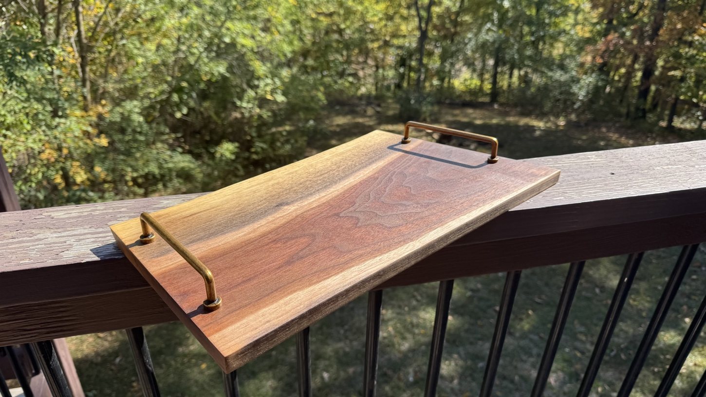 Handcrafted wooden serving board with brass handles